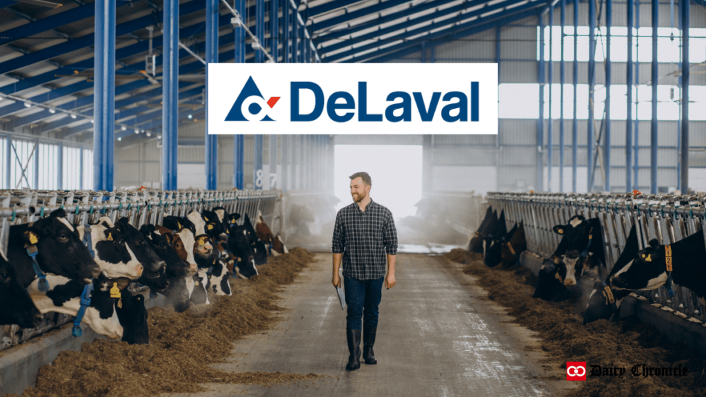 Barn of cows with a man and the DeLaval logo showcasing the VMS™ Batch Milking system for efficient robotic milking