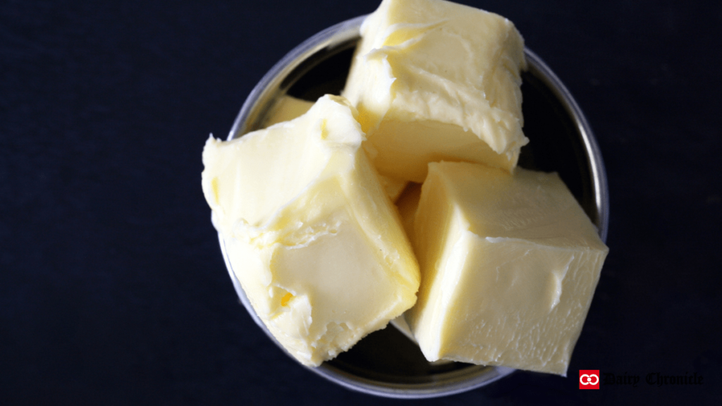 Three cubes of butter in a bowl with a high price tag backdrop