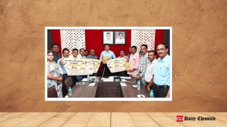 A group of people holding a banner that reads 'Chittoor Plans to Boost Milk Production and Support Dairy Farmers