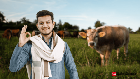 A young boy standing with a cow in the background on the ground, symbolizing Indian Government support for dairy growth