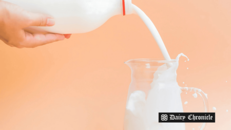 Milk pouring into a glass, representing the rising demand benefiting UK dairy farmers.