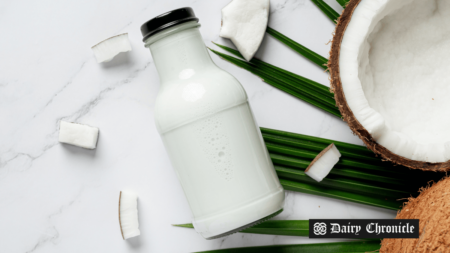 Coconut milk bottle with a half-cut coconut beside it, highlighting the growth of the global coconut milk beverages market.