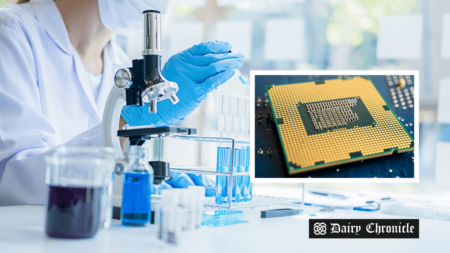 Researcher in the lab with a microchip spectrometer, aiming to reduce milk waste during dairy equipment cleaning