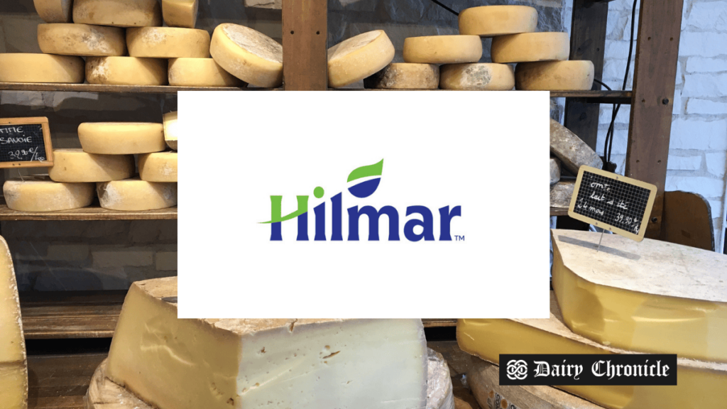 Hilmar Cheese Company logo in the front with a cheese store room in the background, symbolizing the major change as the CEO steps down.