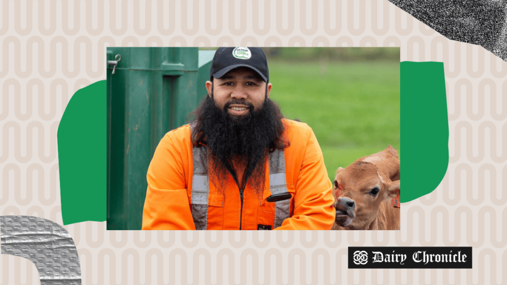 Reza Abdul-Jabbar, a Southland dairy farmer, standing outside his farm, facing the camera with a backdrop of his cattle and farm.