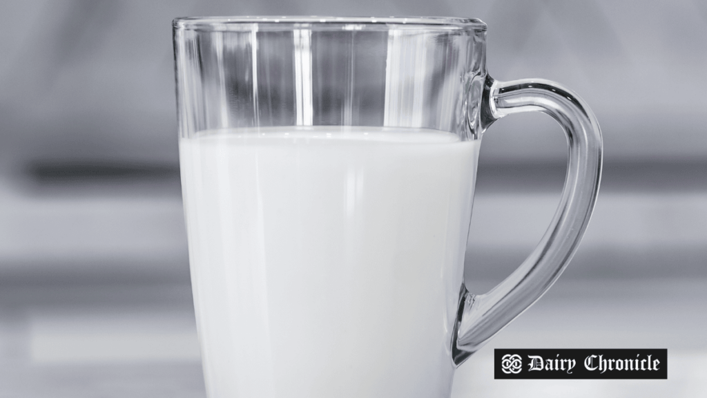 A glass of milk on a table with no cows in sight, representing Brown Foods' innovation in cow-free milk production.